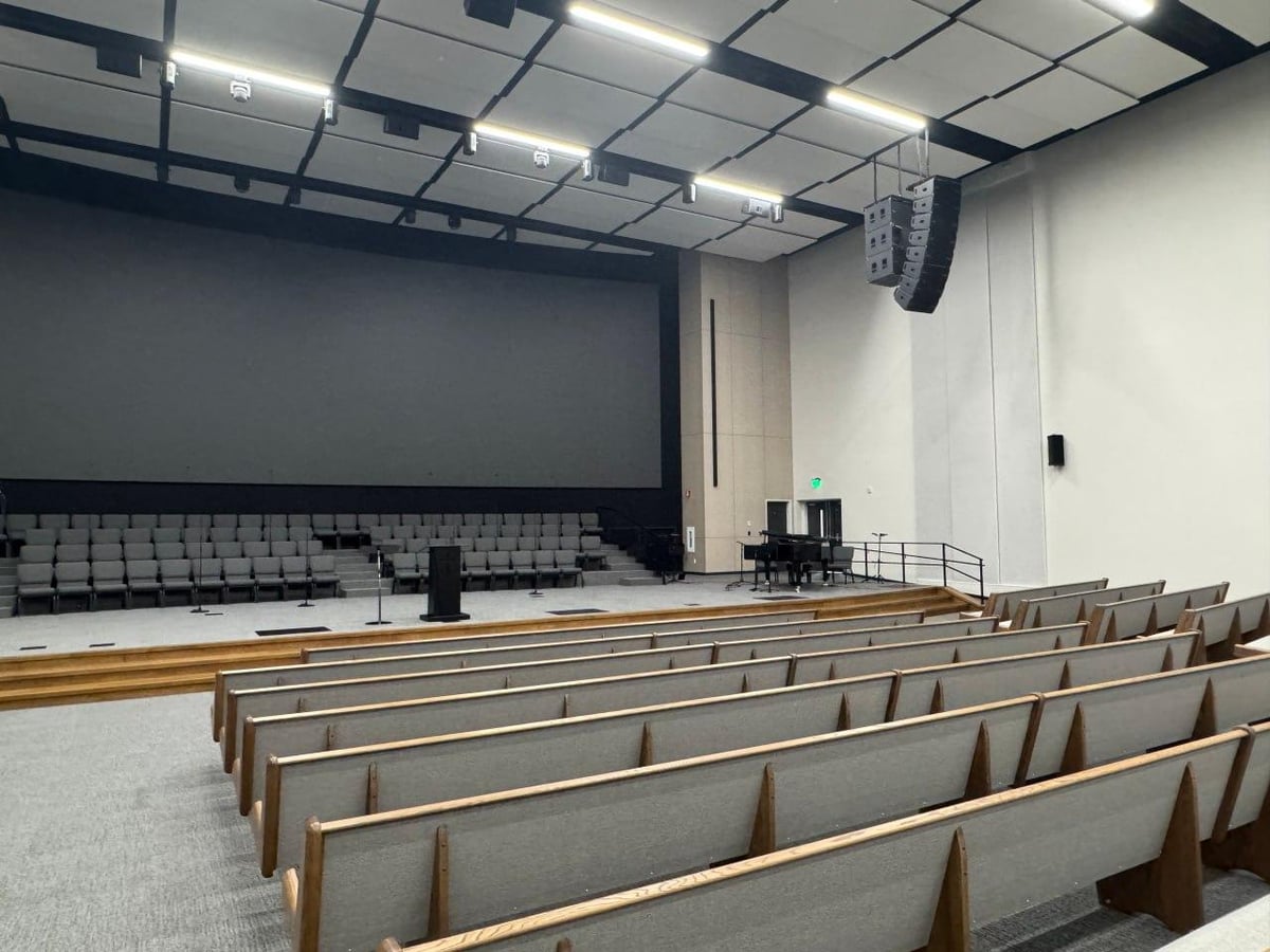 Completed interior of church auditorium with rows of pews and stage in Lake Stevens.