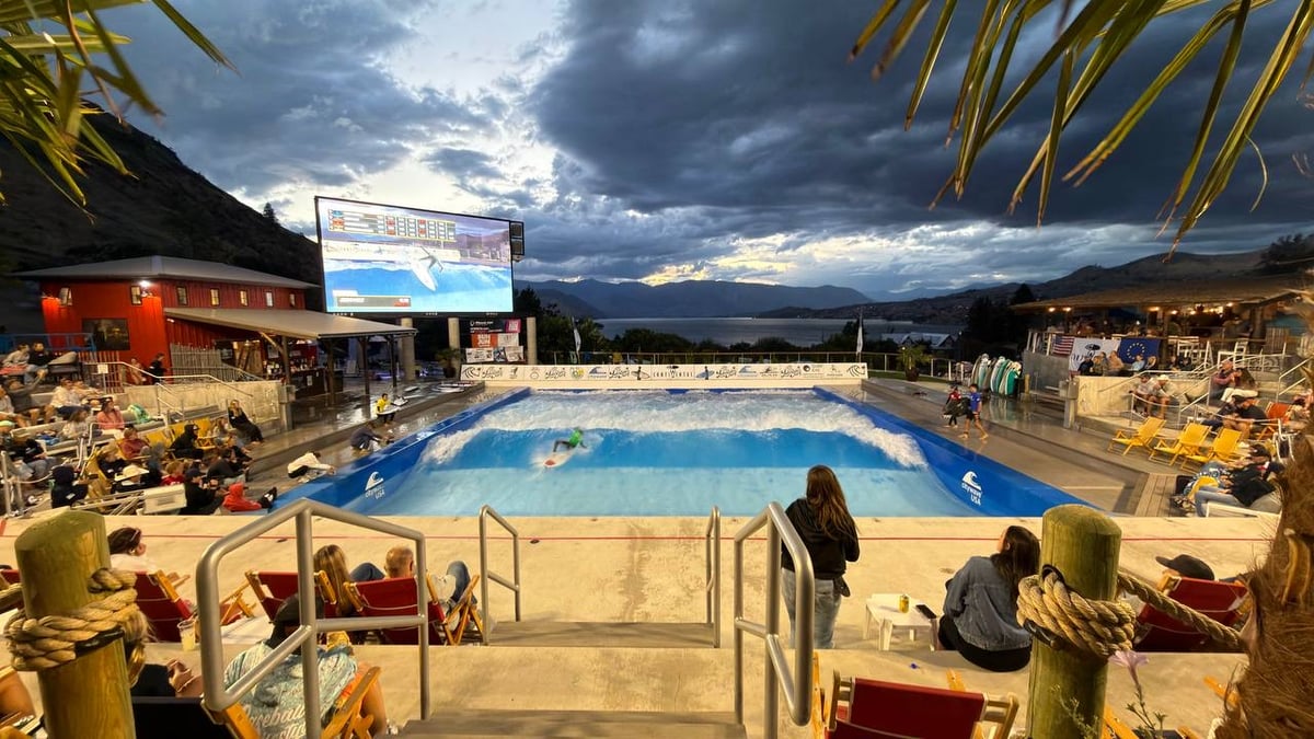 Spectators watch wave pool with Promo Box banner at 2026 Continental Surf Cup in Chelan.