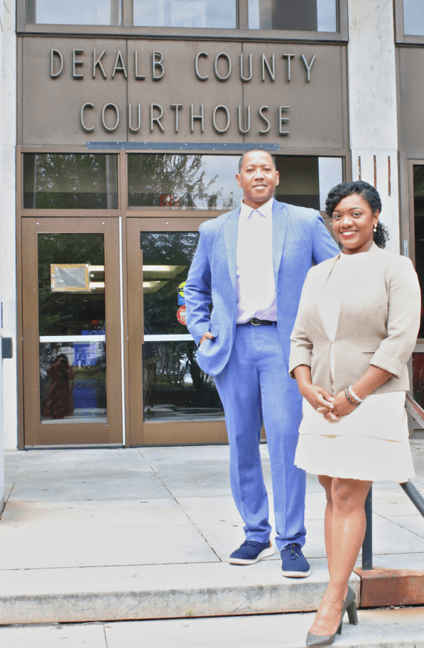 Attorneys Terance Madden and Utrophia Robinson standing in front of the DeKalb County Courthouse entrance in Decatur, GA