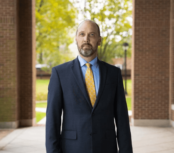 David Deane Law: Virginia's Clean Slate Act Now in Effect — Arlington Criminal Defense Attorney Explains What Changes October 1 David Deane, Arlington criminal defense attorney, standing outside in a navy suit and gold tie