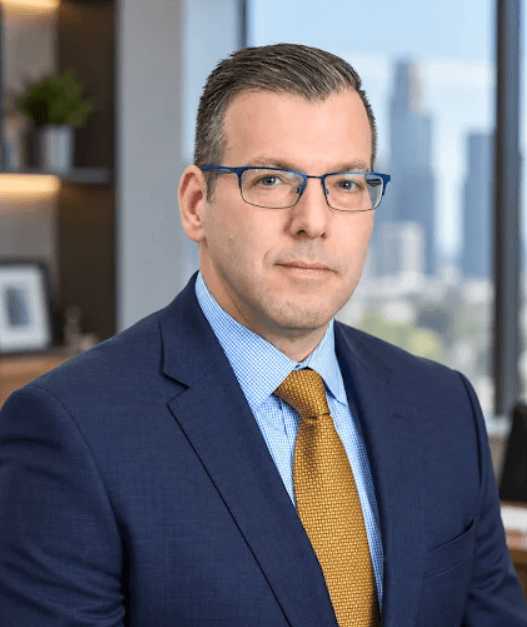 San Antonio military divorce attorney Joseph Lassen in a navy suit and gold tie.