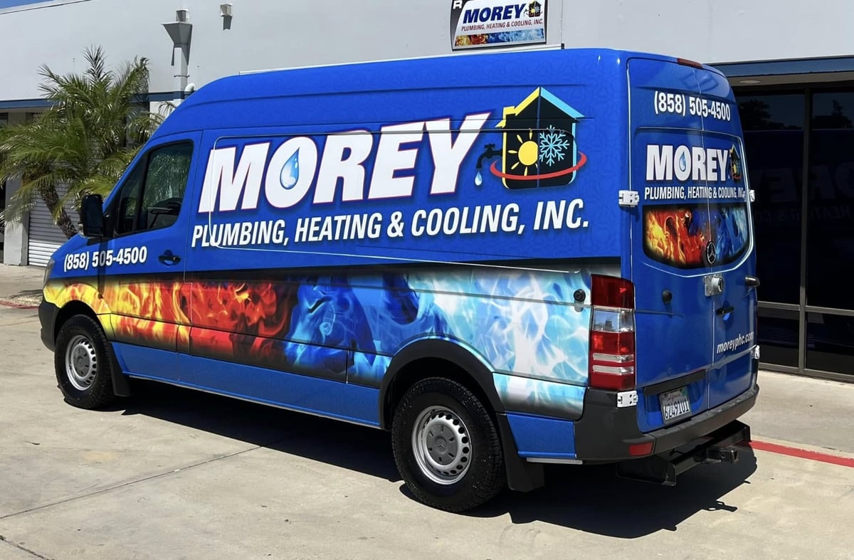Morey Plumbing, Heating & Cooling service van parked outside a San Diego office building.